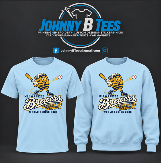 Light blue apparel featuring a swinging barrel character, Milwaukee Brewers script, and “Barrels Up. Bats Out.” front graphic with World Series 2026 lettering.
